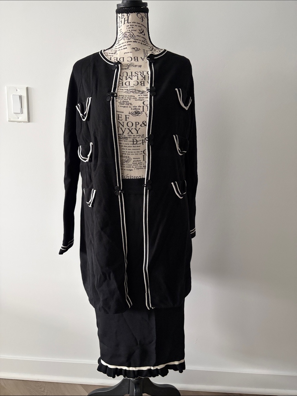 Cyrus longline black cardigan jacket featuring white contrast piping skirt set